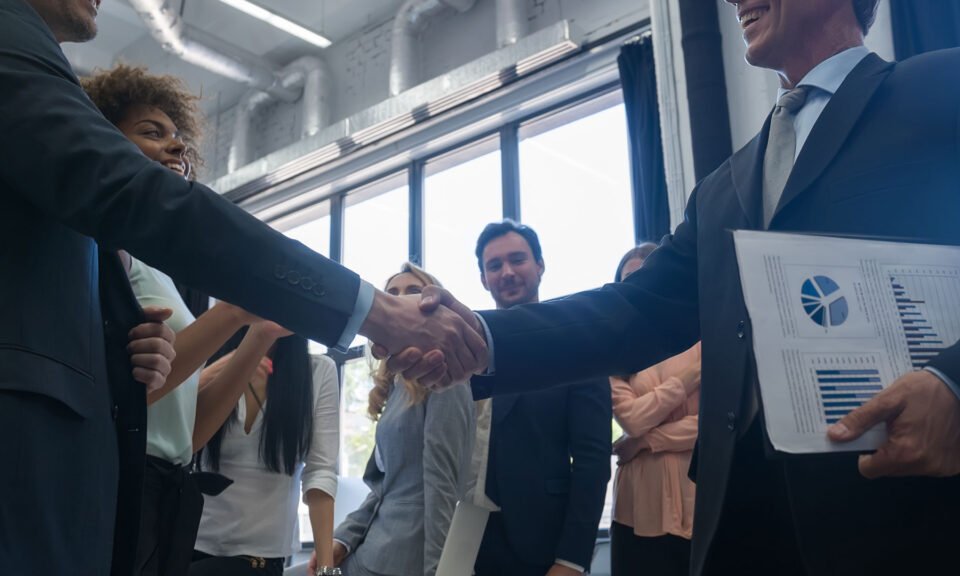 business handshake with businesspeople on backgrou D2PZTEG 1024x576